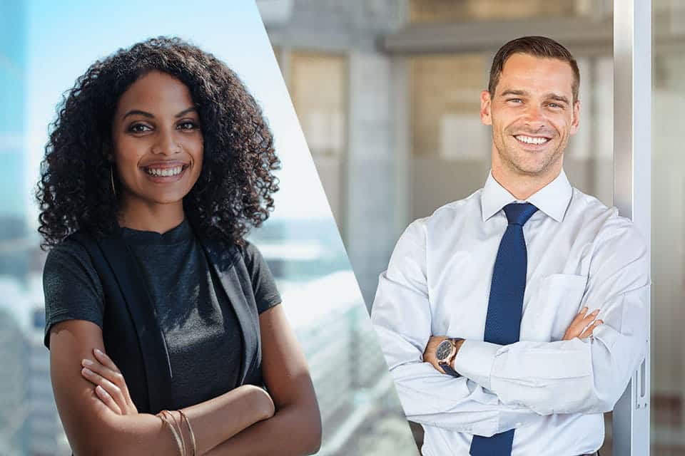 a female and male employee standing with crossed arms smiling wearing professional clothing