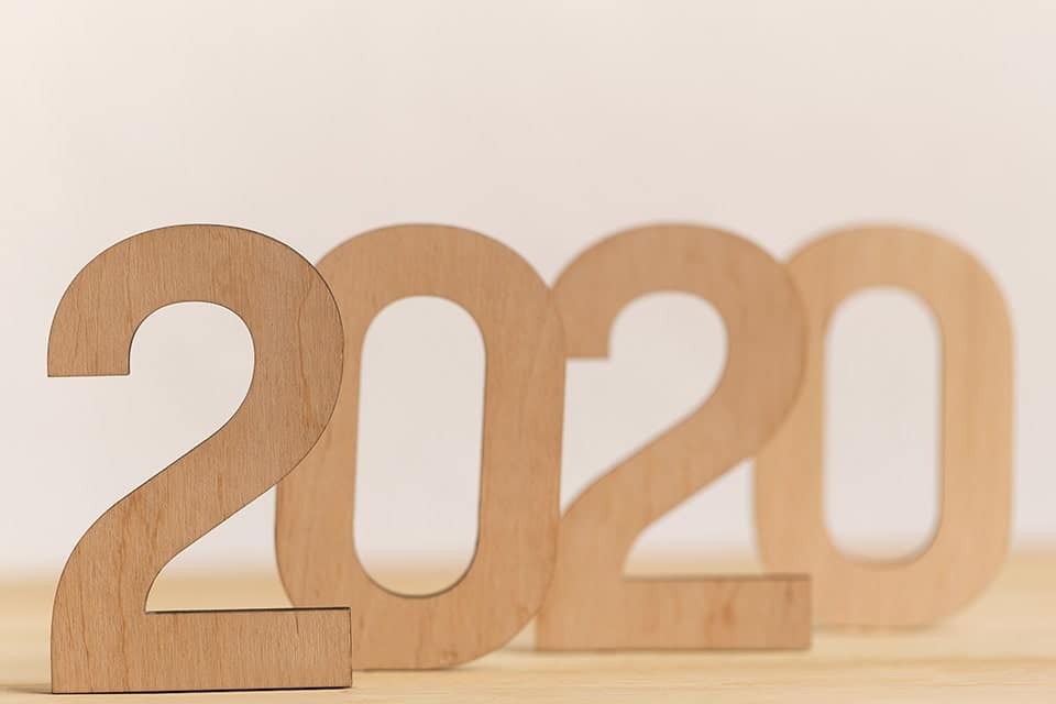 wooden blocks spelling 2020 on a wooden desk
